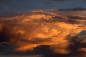 Dramatic sunset sky. Magical view of the dusk red, orange and yellow colors in the clouds and sky. 
