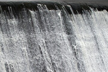 smooth flow of water in river turns into powerful waterfall