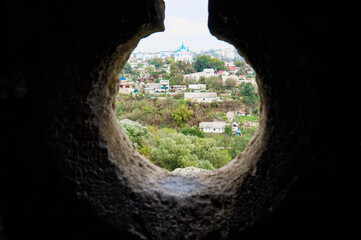 View of the houses in the Smotrych canyon from the loophole of the Kamenets-Podolsk fortress.   