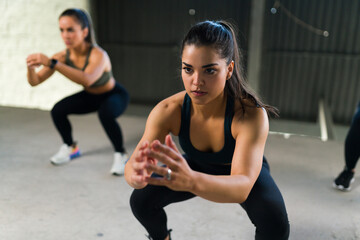 Attractive women working out together at the gym