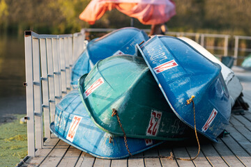 boats lying in a heap on a wooden pier, boats are being dried for further repairs