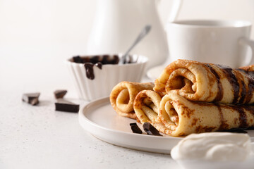 Russian thin pancakes with chocolate on white. Shrovetide. Traditional russian breakfast. Close up. Copy space.