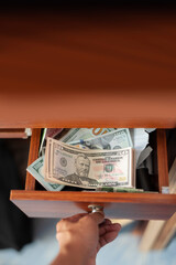 US banknote in drawer with opening hand