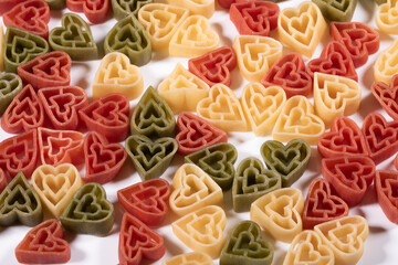 Food background ,Italian three color heart shaped pasta .