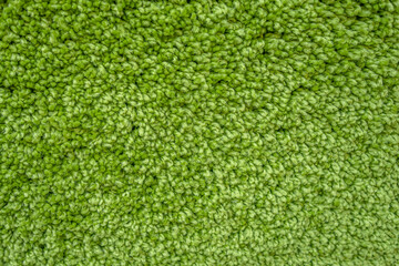 abstract background of bright green carpet texture close up