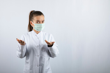 Woman doctor in white uniform wearing a medical mask