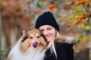 Portrait of a young woman and her cute dog