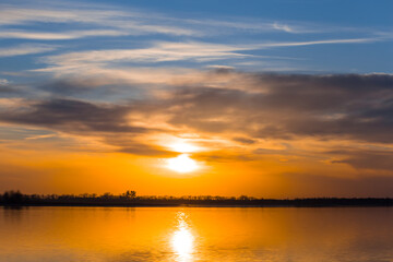 dramatic sunset over the quiet lake, evening outdoor scene