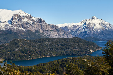 A view of beautiful landscape of snowy mountains and green trees from Cerro Campanario (Campanario Hill) in San Carlos de Bariloche, Rio Negro, Patagonia Argentina.