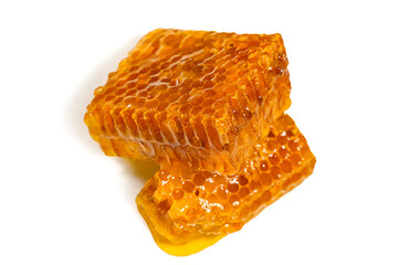 Amber sweet honey in a honeycomb on an isolated white background