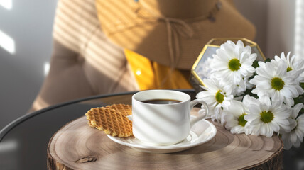White cup with black coffee. Morning coffee, breakfast, cookies, tropical leaf, wicker hat. Summer sunny background. Breakfast on vacation at the hotel. Traveling at sea, close-up.