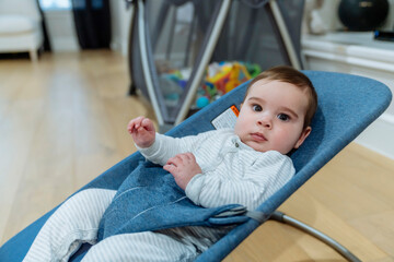 Cute baby boy hanging out in rocker chair