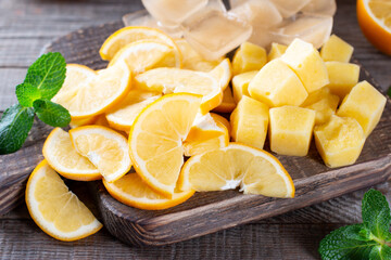 Frozen lemon on a cutting board on a wooden table