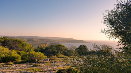 Aerial view of Anchor Bay Malta at sunset