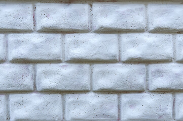 Texture of a gray concrete fence with the shape of a brickwork.