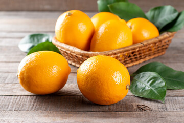 Fresh lemons with leaves on a wooden table