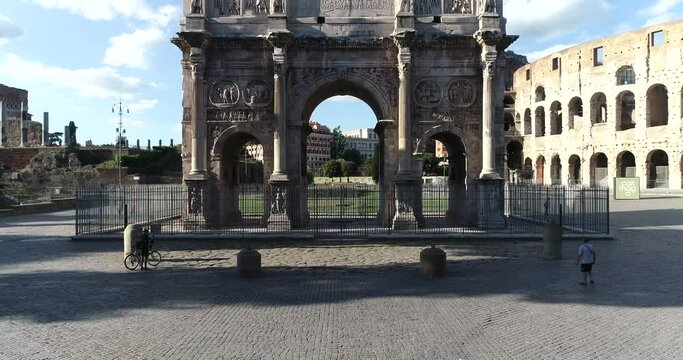 The Colosseum and the Arch of Constantine in Imperial Rome.
Close up aerial view with vertical movement