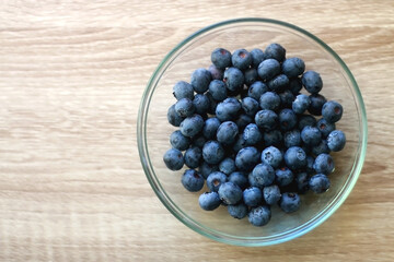 Bowl of blueberries on the table. Top view.