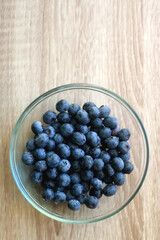 Bowl of blueberries on the table. Top view.