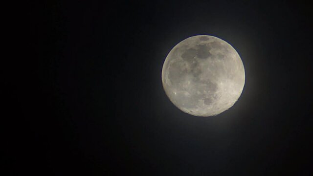 moon is gradual covered by clouds until its fully obscured