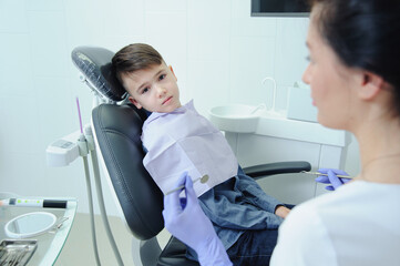 A child boy with a dentist in a dental office