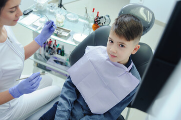A child boy with a dentist in a dental office