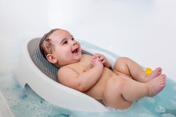 Cute, happy, chubby, naked baby in bath