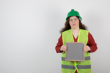 Image of a young cute girl with down syndrome standing in vest