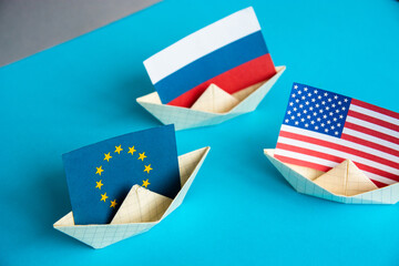 paper ship with national flag of America Usa, Russia and Europe concept of sanctions and partnerships and free trade agreement, confrontation