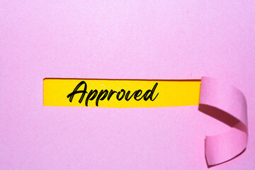 The Text Approved appearing behind the torn paper.