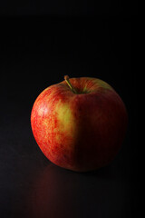 An apple against black background