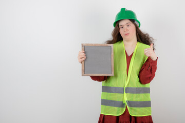 Image of a young cute girl with down syndrome standing in vest