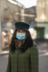 woman in a city . Girl in a mask . Coronavirus theme .