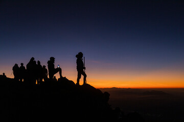 Silhouette woman climber at sunset on top of the Acatenango volcano in Guatemala-young woman...