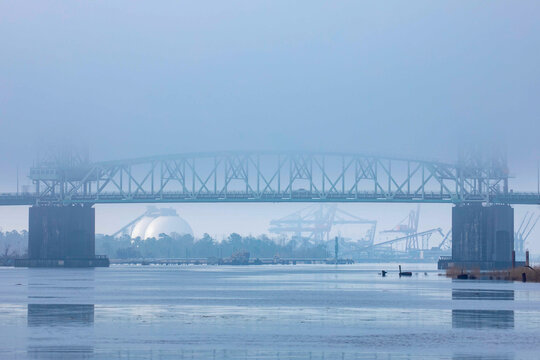 Industrial Bridge Over River with Fog