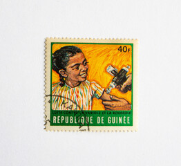 Guinea Republic Postage Stamp. circa 1972. The fight for measles and smallpox control. vaccination girl