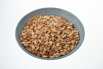 Salted crispy roasted broad beans in blue bowl on white