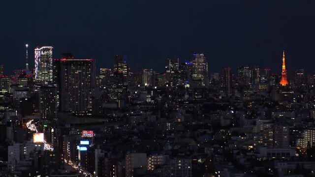 TOKYO, JAPAN : Aerial sunrise CITYSCAPE of TOKYO. View of dawn city and buildings at downtown area. Japanese urban city life and metropolis concept. Long time lapse zoom out video, night to morning.