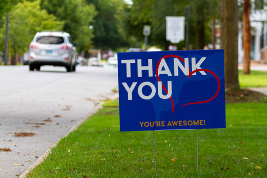 a yard sign by street saying "Thank you, you are awesome" in white and orange text on blue background. A red heart symbol is embedded. Customizable versatile image with copy space for additional text