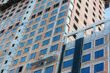 Fototapeta premium scaffolding on a building wall. building getting a new paint.