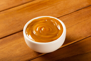 Close-up of jar full of dulce de leche. Dulce de leche, traditional sweet in Latin America.