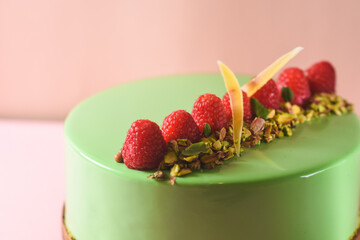 mousse cake with pistachio and raspberry flavor. homemade desserts. gourmet cake with an unforgettable taste - a masterpiece of culinary art on a pink background