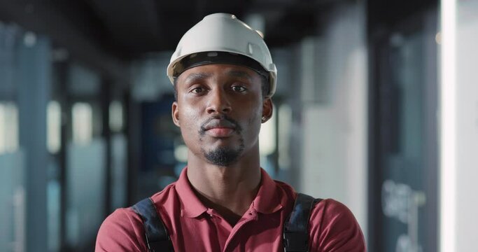 Portrait of confident electrician young worker professional standing corridor of construction site posing at camera. Heavy industry job. Engineering concept.