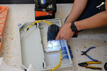Technicians are cutting and fusion fiber optic cables.