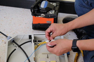 Technicians are cutting and fusion fiber optic cables.