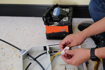 Technicians are cutting and fusion fiber optic cables.