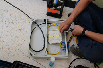 Technicians are cutting and fusion fiber optic cables.