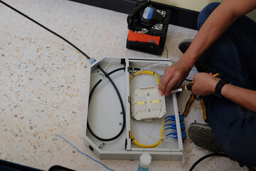 Technicians are cutting and fusion fiber optic cables.