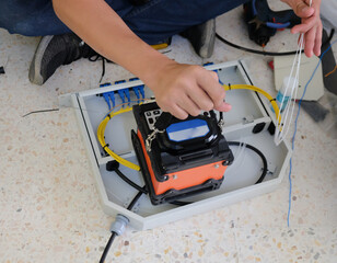 Technicians are cutting and fusion fiber optic cables.