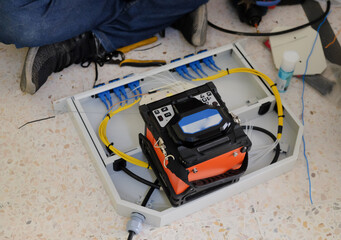 Technicians are cutting and fusion fiber optic cables.